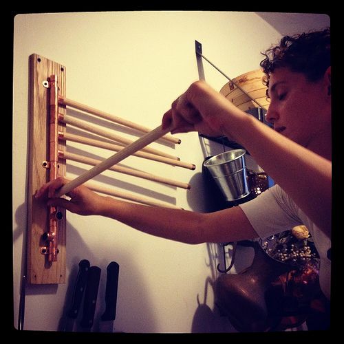 a man is working on some kind of rack with wooden dows and other tools