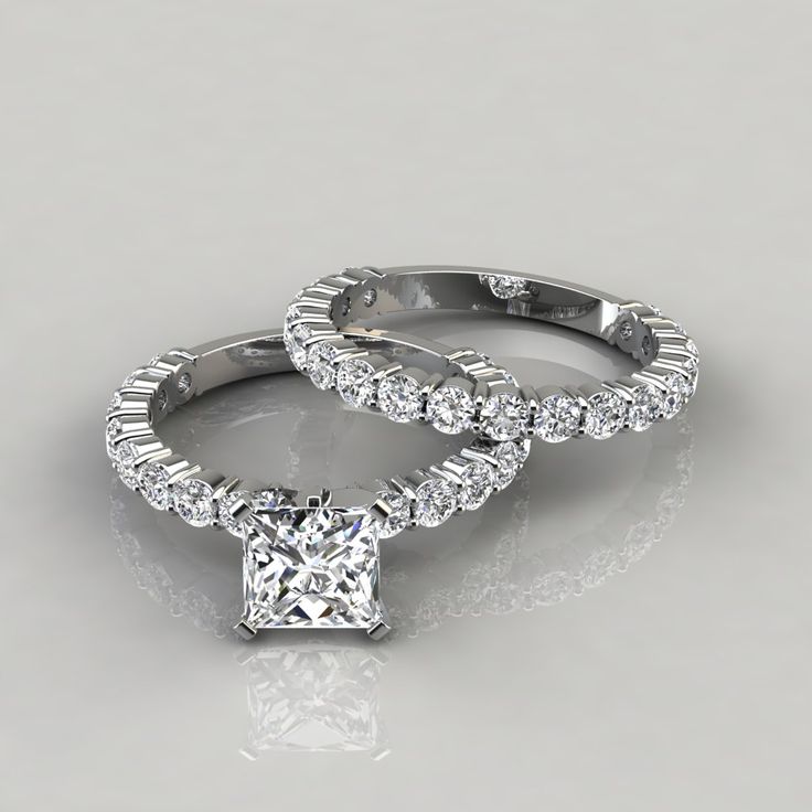 two engagement rings with diamonds on them