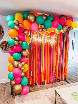 a room decorated with balloons and streamers