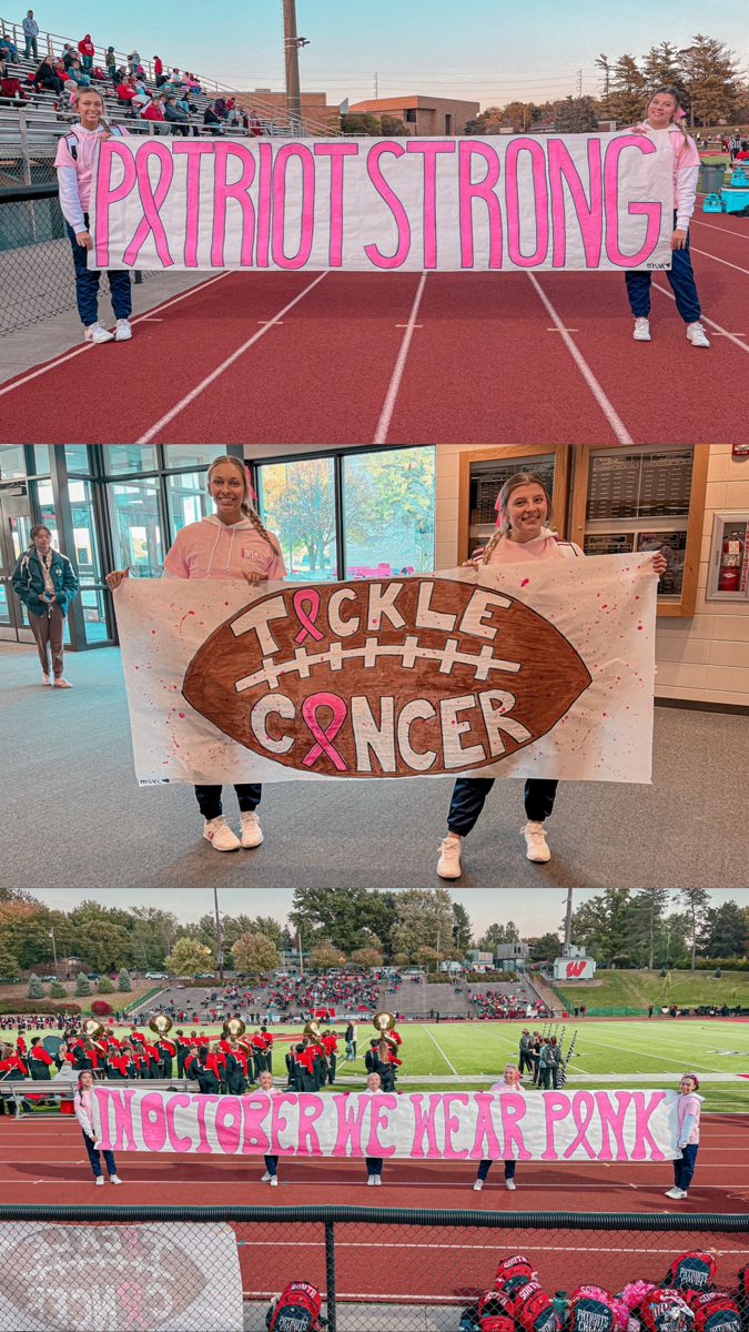 two girls holding up signs in front of a football field with people standing on the sidelines