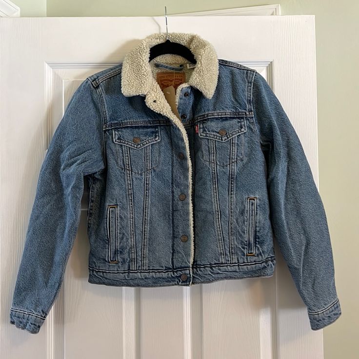 Women’s Levi’s Sherpa Lined Jean Jacket. Size Medium. Nwt And Never Worn Before. Super Warm! Love This Jacket But It’s Too Small. Runs A Bit Smaller Than A Normal Medium. Denim Jacket With Faux Fur Lining For Fall, Fall Denim Jacket With Fleece Lining And Long Sleeves, Fall Denim Jacket With Fleece Lining, Long Sleeve Denim Jacket With Fleece Lining For Fall, Levi's Blue Outerwear For Fall, Levi's Winter Denim Jacket, Levi's Fitted Outerwear For Cold Weather, Levi's Winter Outerwear In Medium Wash, Levi's Medium Wash Winter Outerwear