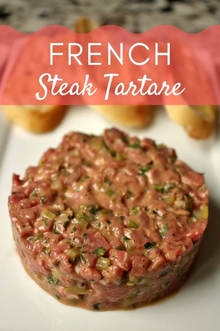 french steak tartare on a plate with buns in the background