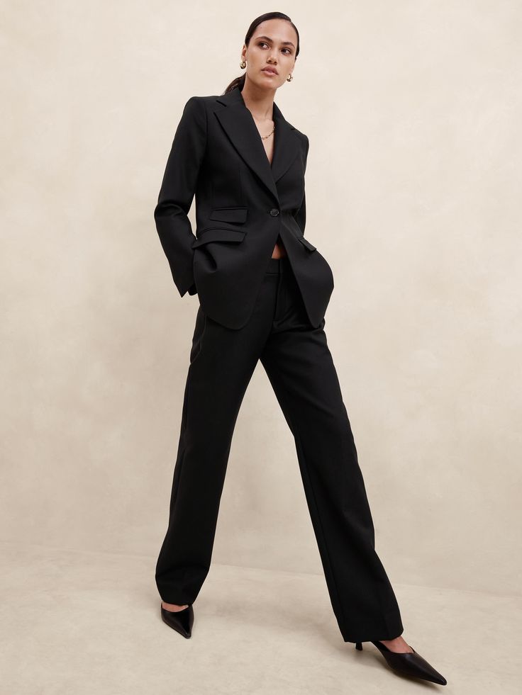 Sharp and smart, this extra long pant is cut to wear with your favorite heels.  A high waist and straight leg adds length to every step.  ITALIAN WOOL: Soft and smooth, this wool fabric from Italy's Marzotto mill is perfect for cooler weather.  Zip fly with hook-and-bar closure.  Belt loops.  Front and back pockets.  Unlined.  As seen on Vogue World: New York Straight Fit: High rise (10. 25").  Slim through the hip and thigh, straight leg.  Extra long length - so you can wear them with heels.  Inseams: Petite/Short 31", Regular 33", Tall 36" Model: Size 2, 12 or 18, 5'10" (178cm).  Dry clean. Luxury Tailored Trousers Pantsuit, Fall Evening Pantsuit With Pressed Crease, Fitted Black Wool Wide Leg Pants, Formal Black Wool Wide Leg Pants, Luxury Straight Leg Pantsuit For Work, Sleek Wide-leg Pantsuit For Business, Chic Straight Silhouette Pants For Evening, Elegant Formal Wide Leg Pants With Straight Silhouette, Sleek Wide Leg Pantsuit For Business