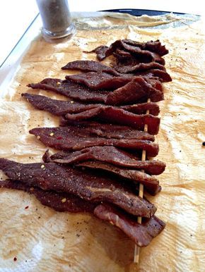 bacon strips are lined up on a cutting board