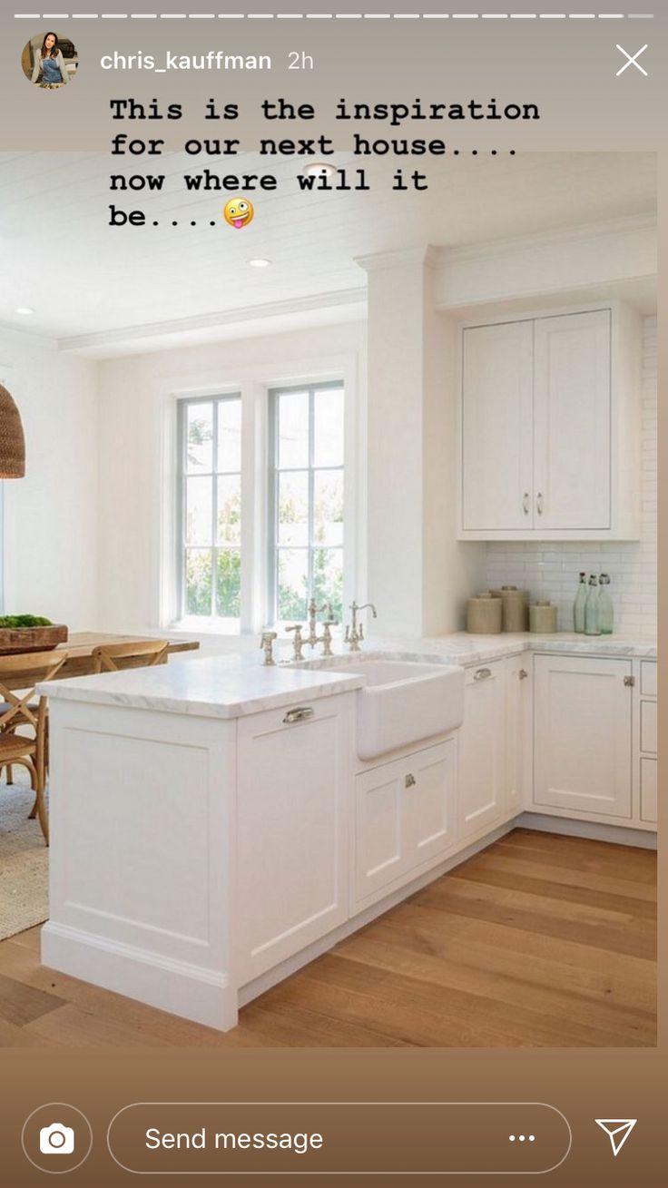 a kitchen with white cabinets and wooden floors