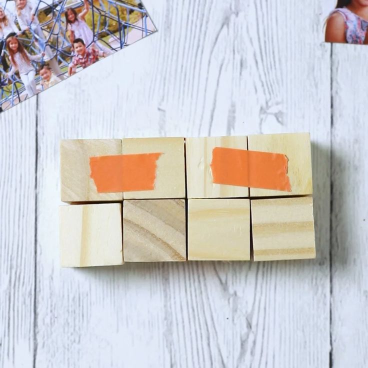 a wooden block with orange paint on it next to photos and a photo collager