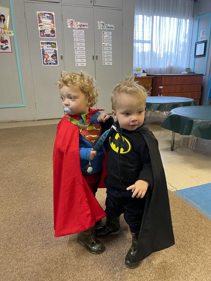 two young boys dressed up as superman and batmangirl