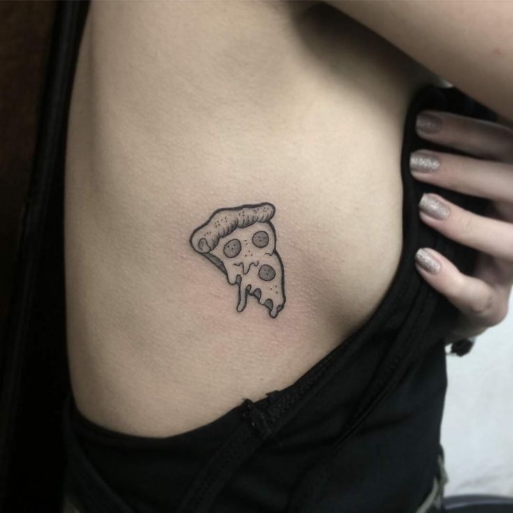 a woman with a tattoo on her stomach has a slice of pizza in the shape of a skull