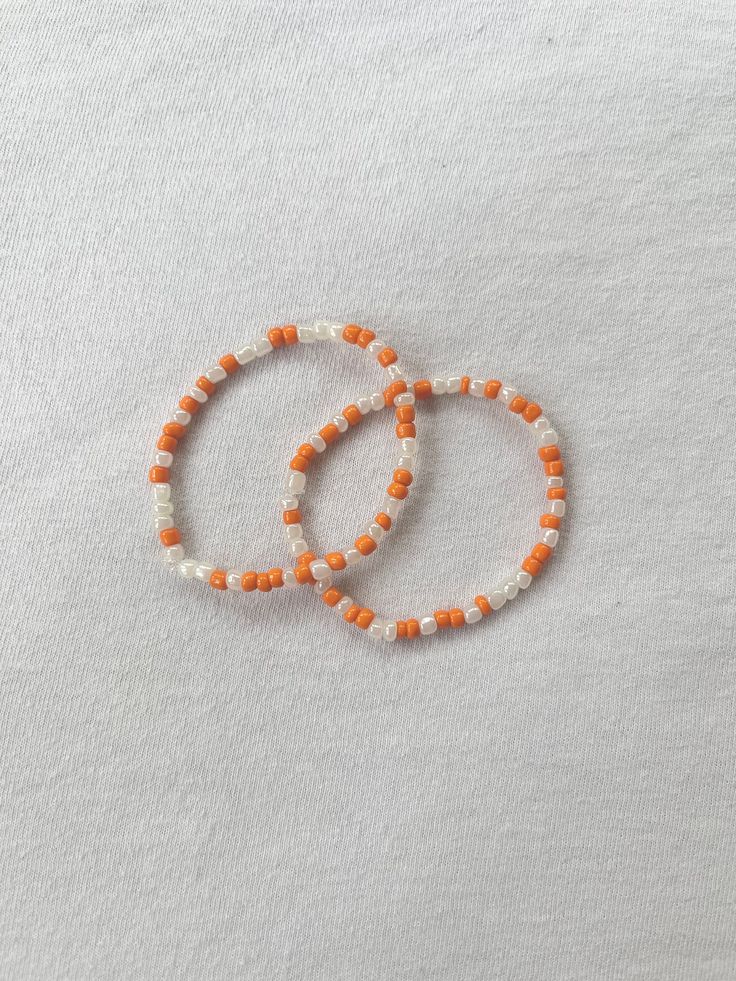 This bracelet is perfect for fall and is handmade! Fall Stretch Bracelets, Handmade Orange Friendship Bracelets For Everyday, Orange Handmade Friendship Bracelets, Handmade Orange Casual Friendship Bracelet, Casual Handmade Orange Friendship Bracelets, Casual Handmade Orange Friendship Bracelet, Orange Beaded Bangle Bracelet As Gift, Handmade Orange Beaded Bangle Bracelets, Orange Bangle Stretch Bracelet For Gift