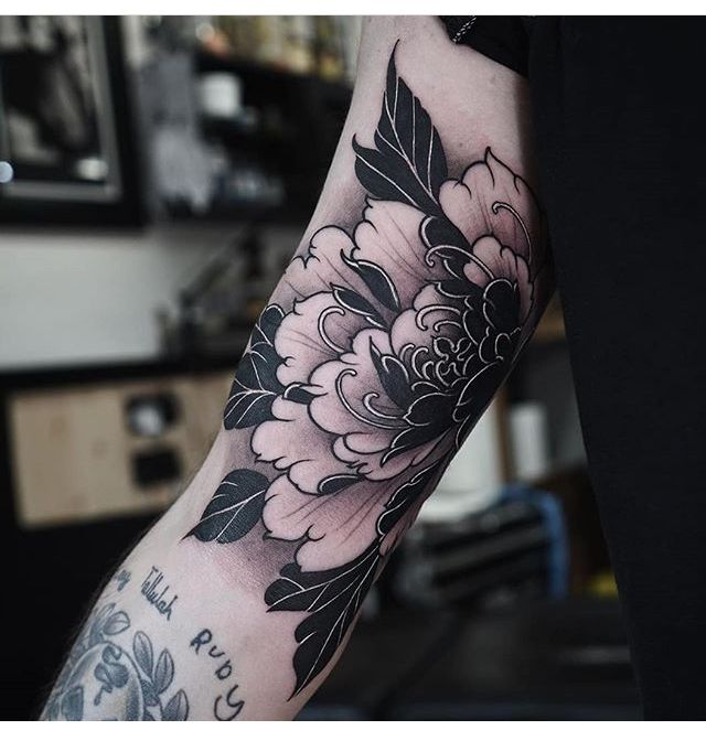 a person with a flower tattoo on their arm