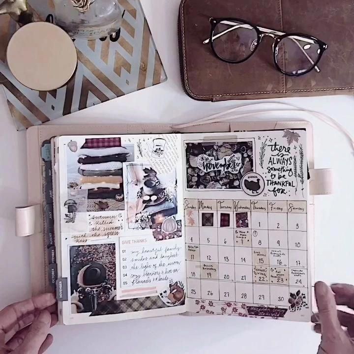 an open planner with glasses on top of it next to a purse and other items