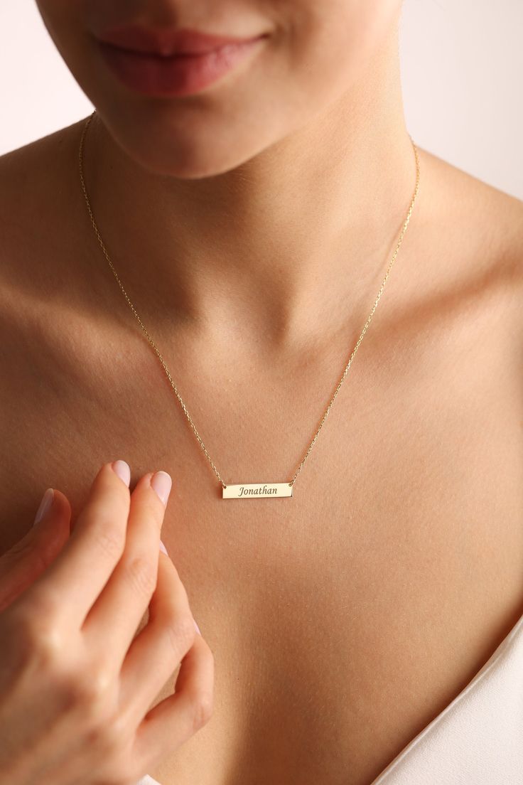 "Gold bar necklaces are elegant and tiny personalized bar necklace on a stunning dainty chain. Customize with your choice of engraved initials, names, number, dates and more. Custom name necklaces are unique personalized gifts that you can give to your loved ones.  Also dainty bar necklaces, initial necklaces are going to look stunning on you! ✨ Great gift idea for mom necklace gifts, valentines gifts, anniversary gift, birthday gifts, Christmas gifts and more. ✋ All our jewelry is %100 custom made by hand with Love and Care in our workshop! ✨ All our products High Quality Solid 925 Sterling Silver  Nickel Free High Quality Materials Standard Deliver in 6-9 Business Days Name size - lowercase letters are approximately 4 mm and uppercase letters are approximately 6 mm. *How to customize Ord Everyday Minimalist Customized Charm Necklaces, Customized Minimalist Name Necklace, Minimalist Nameplate Necklace, Minimalist Custom Name Necklace, Minimalist Nameplate Charm Necklace, Minimalist Everyday Nameplate Charm Necklace, Minimalist Bar Necklace For Mother's Day Personalized Gift, Minimalist Name Bar Necklace For Mother's Day, Personalized Dainty Bar Necklace For Everyday