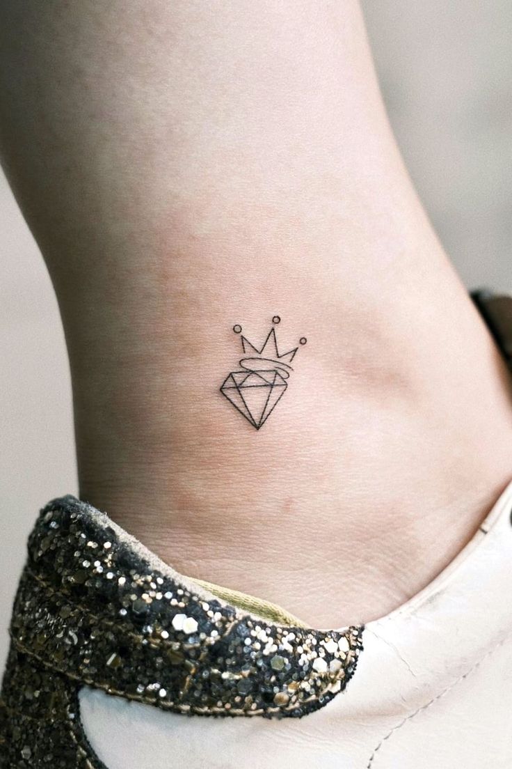 a small crown tattoo on the side of a woman's lower back ribcage