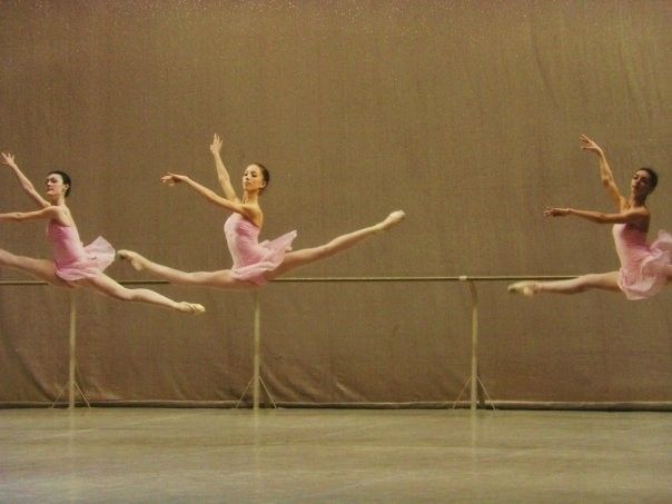 three ballerinas in pink tutu and leotards are doing ballet moves