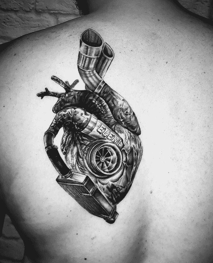 a man with a tattoo on his back that has a heart and pipes attached to it