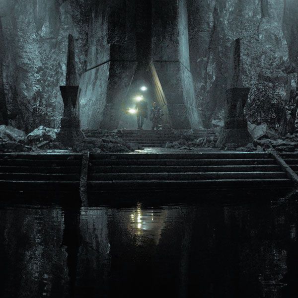 a man standing in the middle of a dark forest