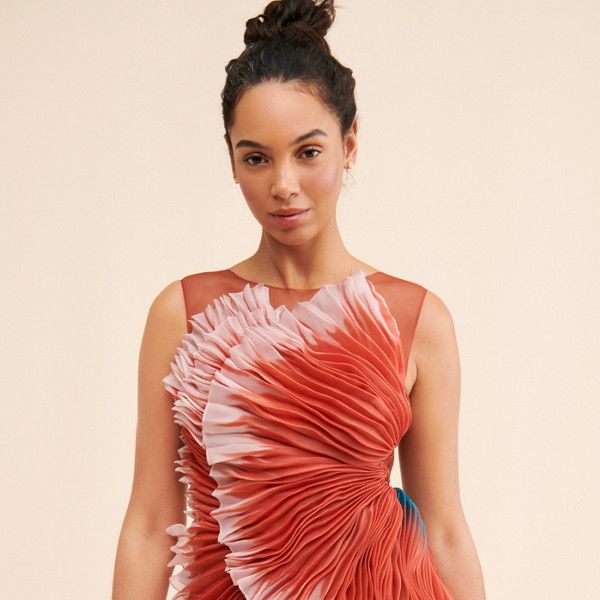 a woman in a red and white dress posing for the camera