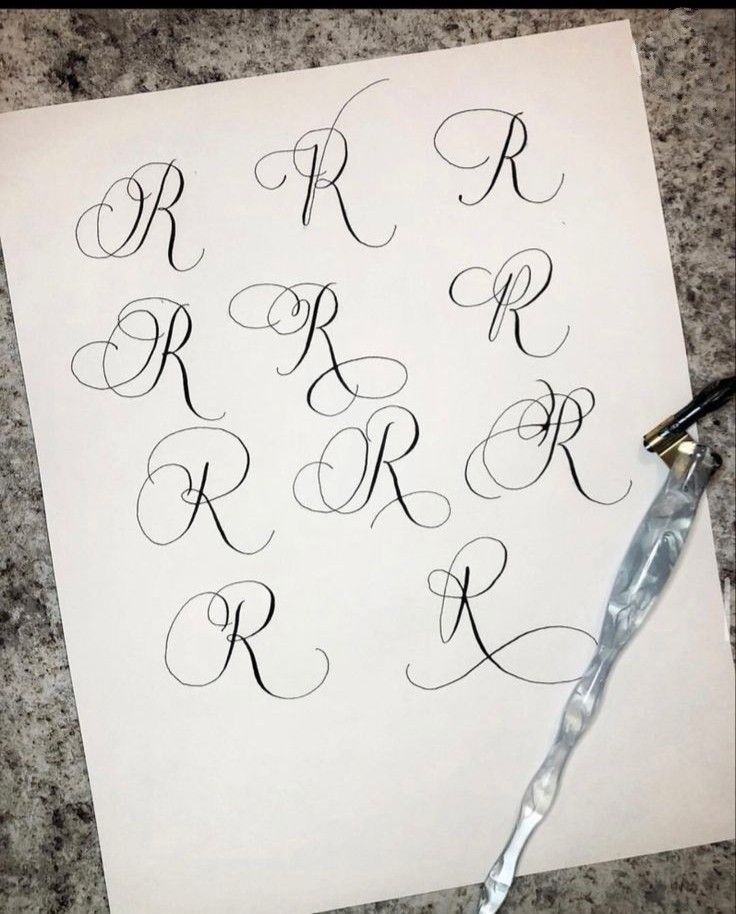 the letters are written in cursive writing on paper with an ink pen next to it