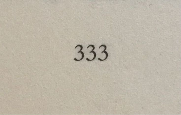 the number 333 is written in black ink on a white paper with writing underneath it