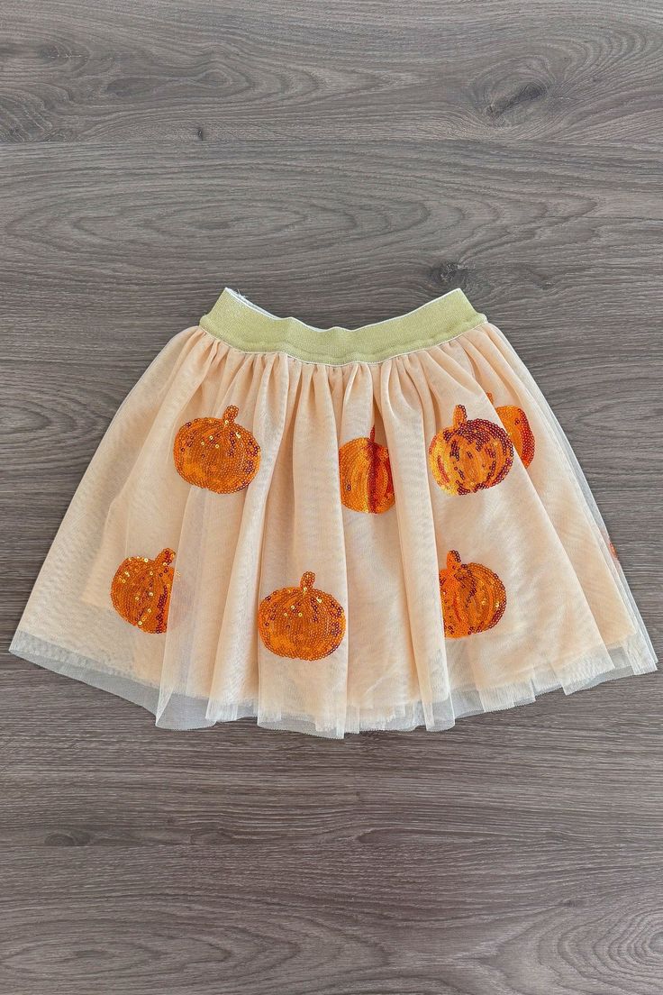 Perfect for Fall & Halloween Skirt features a cream tutu design & sequin pumpkins Skirt also features a stretch waistband with a built in slip for extra coverage Bring on Fall with our Sequin Pumpkin Tutu Skirt! This skirt features a cream tulle design with orange sequin pumpkins allover. Sporting a comfortable waistband for a secure fit, as well as the cream tulle overlay, this skirt is the perfect addition to your little one's closet. Pair this fun skirt with a variety of SIP tops or our booti Tutu Design, Pumpkin Skirt, Pumpkin Tutu, Sequin Pumpkin, Halloween Skirt, Sparkle In Pink, Tutu Skirt, Fall Halloween, Pumpkins