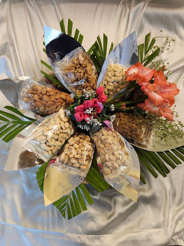 a bunch of flowers that are on top of a table cloth with some kind of food in it