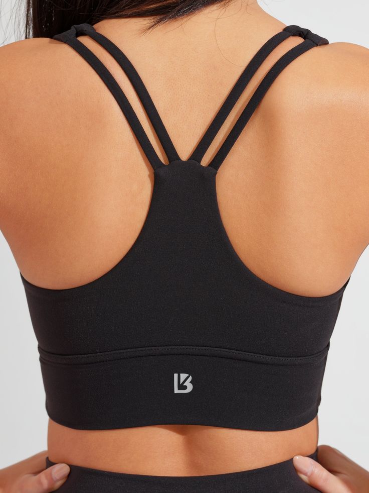 The Bloom Sports Bra is a long-line sports bra with a flattering sweetheart neckline and a light to medium level of support to highlight your best features. It has thick front straps leading to a strappy back and a subtle sinch between the cups. This bra is made with our signature NuBre fabric for a soft, second skin feel with high stretch retention. Black Cross Back Activewear With Built-in Padding, Fitted Yoga Bra With Built-in Padding, Stretch Strappy Sports Bra With Built-in Padding, Fitted Strappy Activewear For Training, Strappy Fitted Activewear For Training, Fitted Sports Bra With Built-in Bra And Cross Back, Black Stretch Bra With Built-in Padding, Fitted Strappy Nylon Sports Bra, Padded Nylon Sports Bra With High Stretch