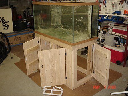 a fish tank sitting in the middle of a room filled with boxes and other items