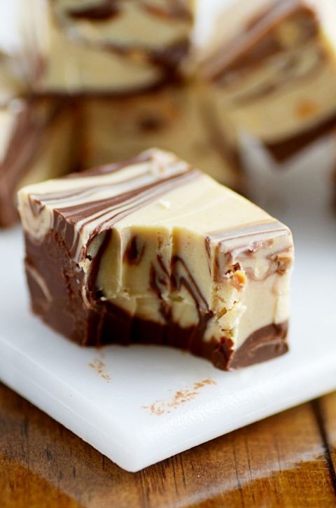 pieces of chocolate and caramel swirled cheesecake on a white plate