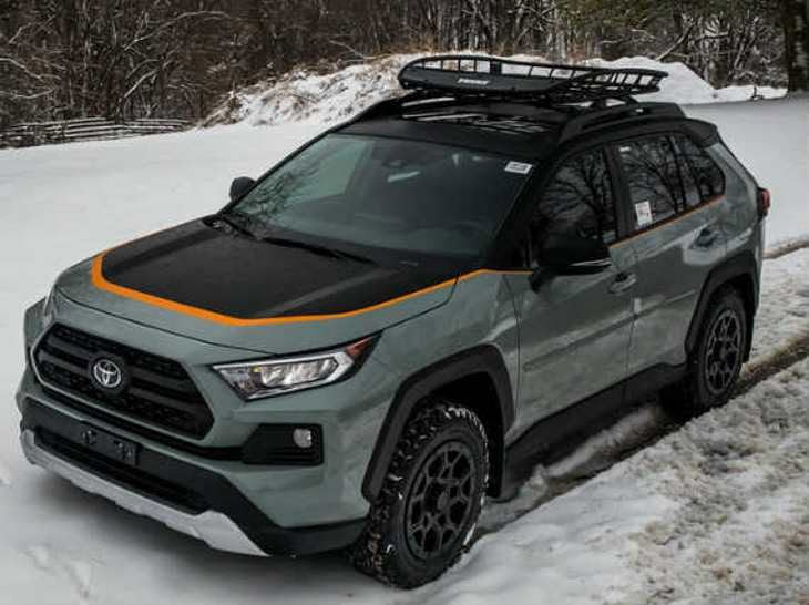 a gray and orange toyota rav parked in the snow