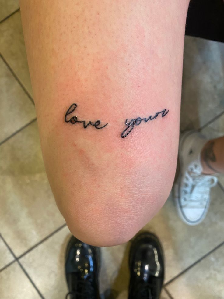 a person with a tattoo on their leg that says love you