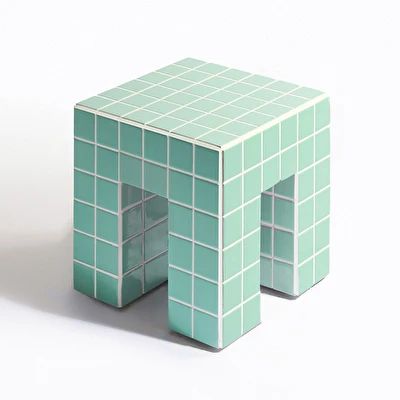 a small table made out of green tiles