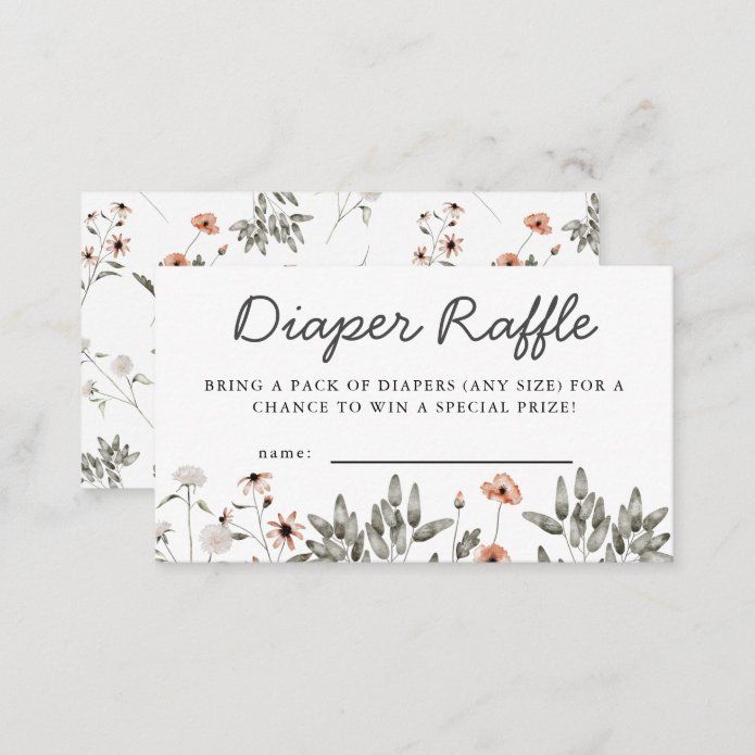 the diaper raffle card is shown with flowers and leaves on white marble background