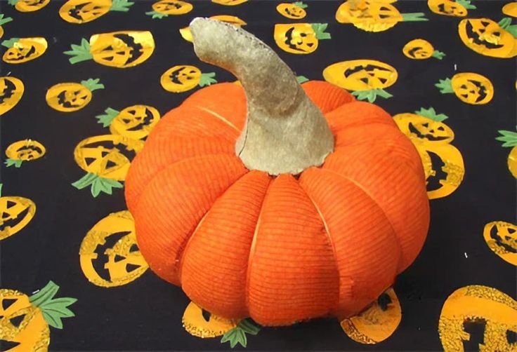 an orange pumpkin sitting on top of a table