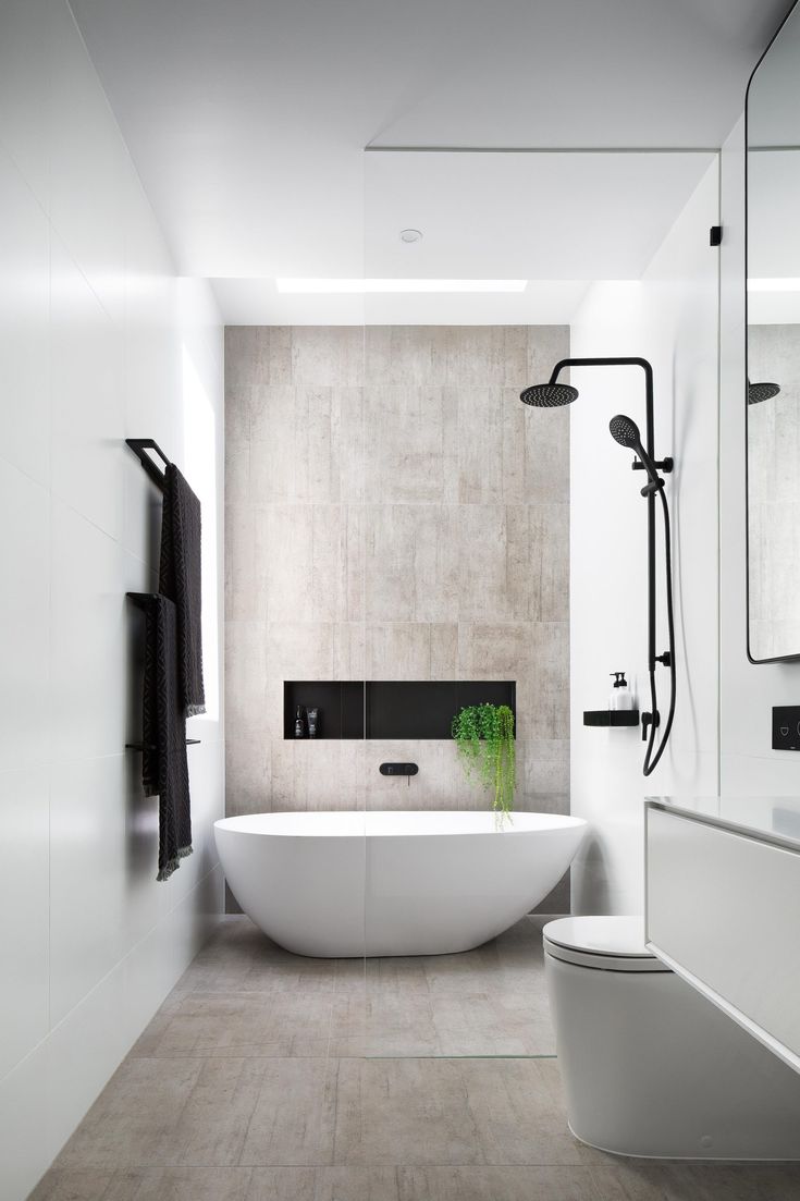 a bathroom with a white bathtub next to a toilet