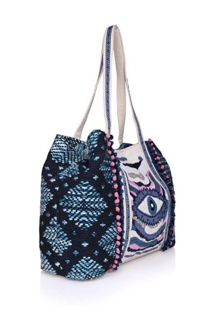 Turn heads with the Smokey Evil Eye Tote, a stunning blend of hand-beaded artistry and intricate embroidery. Lightweight yet spacious, it's the perfect companion for travel, beach outings, or any occasion where you want to stand out. Key Benefits & Features: Evil Eye Design: Hand-beaded and embroidered with the captivating evil eye motif, this tote offers both protection and style. Versatile & Spacious: With dimensions of 24" x 13" x 6", this tote is perfect for carrying your essentials in style Summer Vacation Beaded Shoulder Bag, Summer Vacation Beaded Beach Bag, Summer Beaded Shoulder Bag For Daily Use, Beaded Shoulder Bag For Daily Use In Summer, Multicolor Embroidered Tote Bag For Vacation, Bohemian Beaded Beach Bag For Summer, Multicolor Embroidery Tote Bag For Vacation, Bohemian Beaded Shoulder Bag For Summer, Summer Bohemian Beaded Shoulder Bag