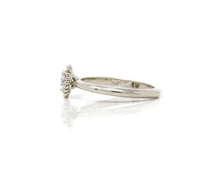 a white gold ring with two diamonds on it