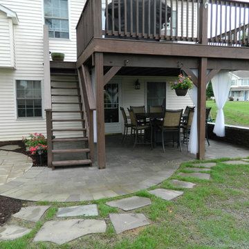 a patio with steps leading up to the deck