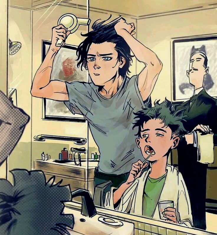 a man brushing his hair in front of a mirror with another man standing behind him