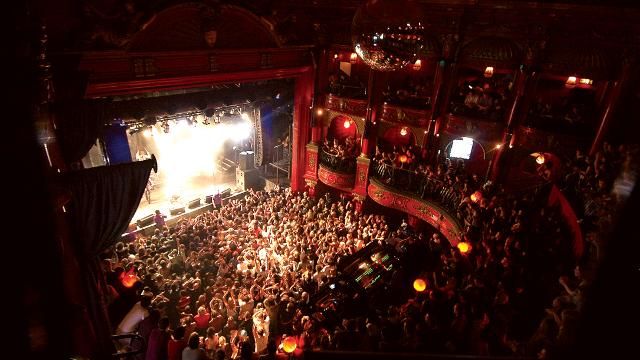 an overhead view of a theatre with people on the stage and in the audience watching