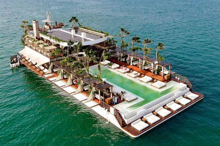 the floating house is surrounded by palm trees