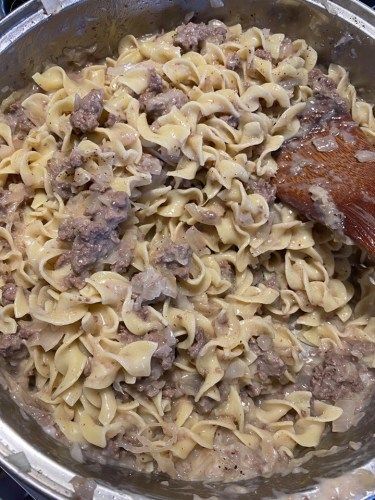 a large pot filled with pasta and meat