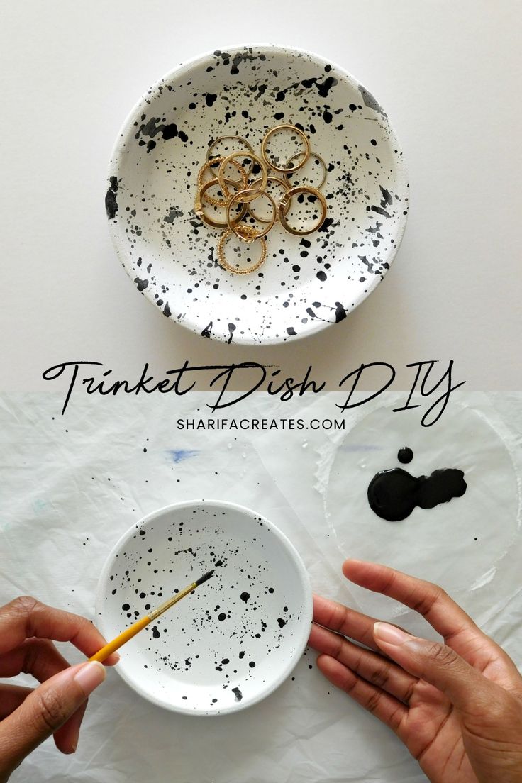 two hands holding a white bowl with black splattered paint on it and the words,