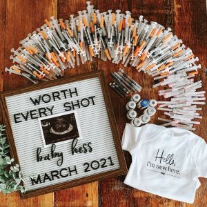 the birth announcement is displayed with t - shirts, pins and other things to put on it