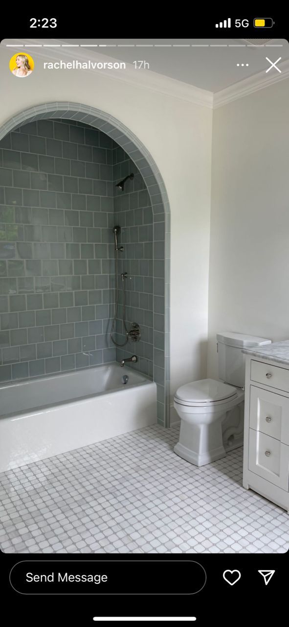 a white toilet sitting next to a bath tub in a bathroom