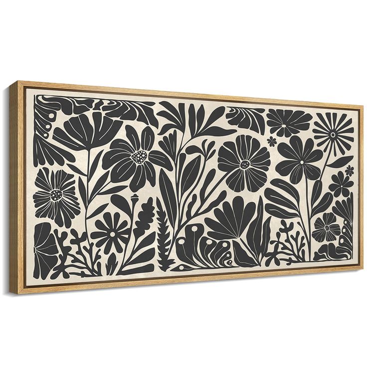 a black and white floral print on a wall above a wooden framed art piece with wood frame