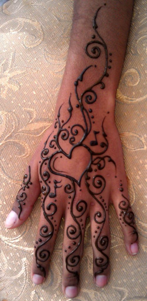 a person's hand with henna tattoos on it