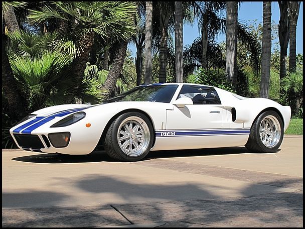 a white sports car parked in front of palm trees