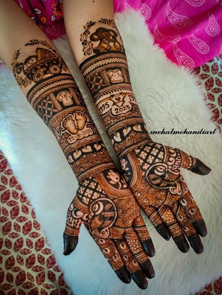 two hands with henna tattoos on them