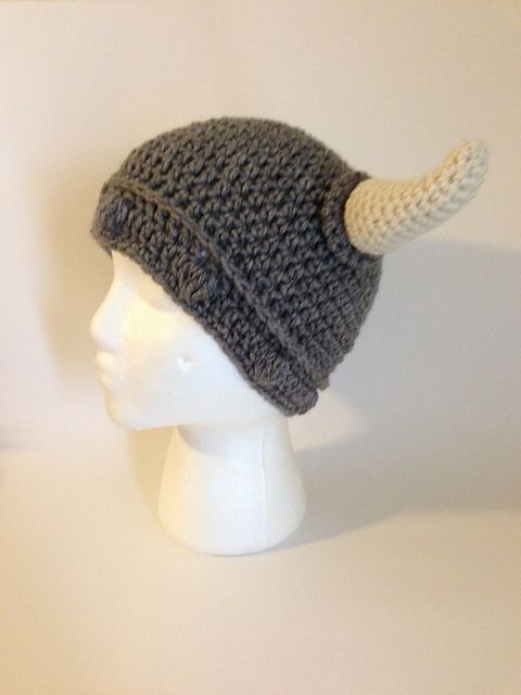 a crocheted hat with horns is on a mannequin head