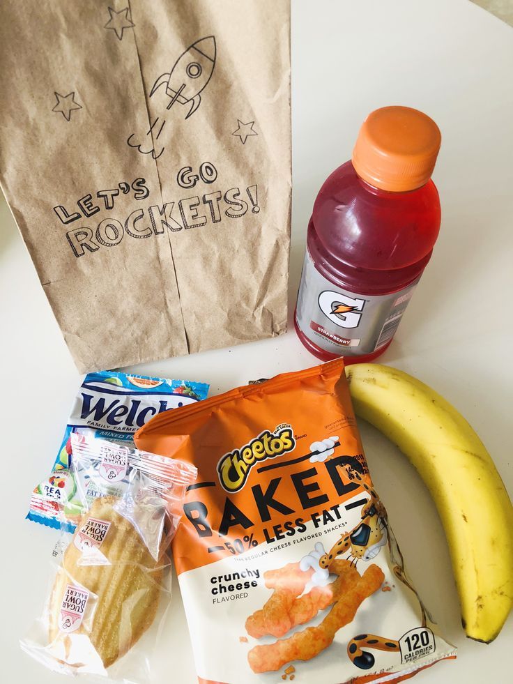 an assortment of snacks sitting on a table next to a bag